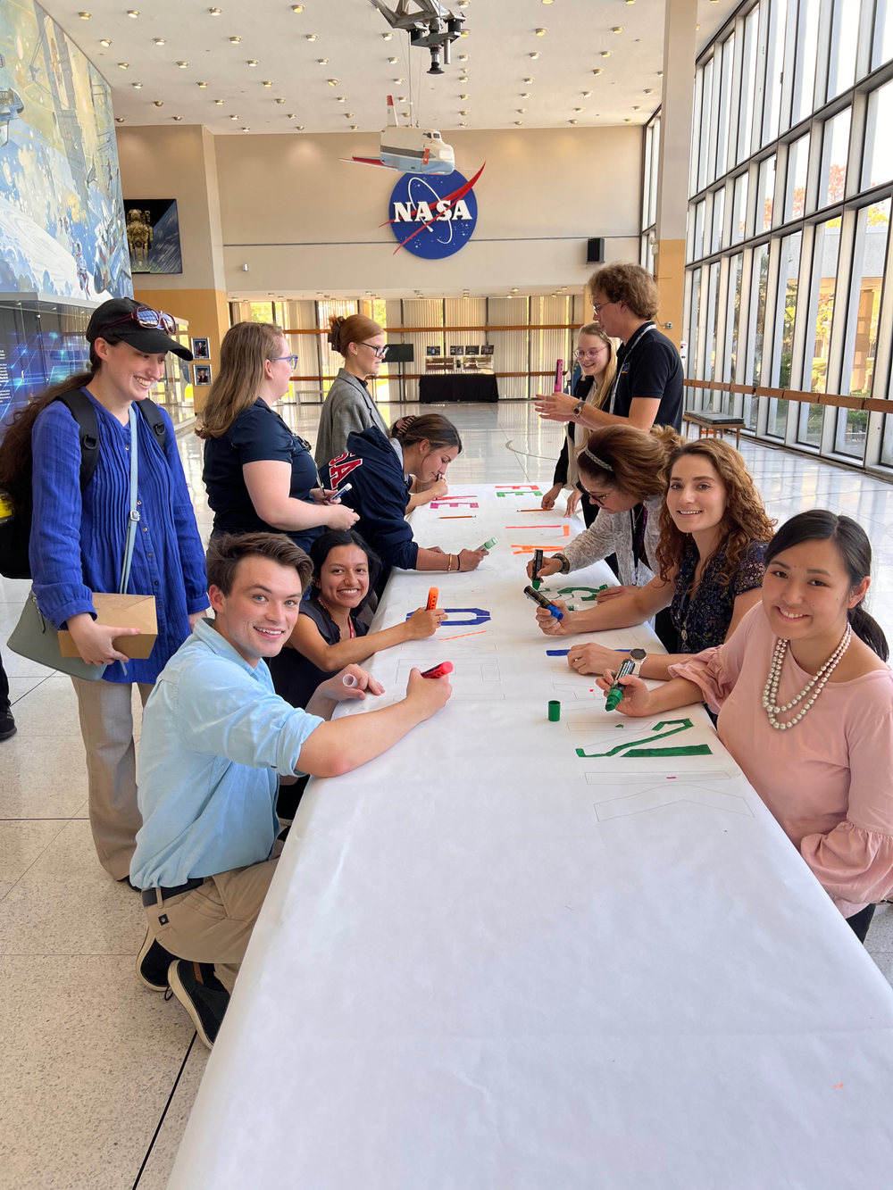 Employees at NASA's Johnson Space Center joining together to make NASA astronaut Frank Rubio a congratulatory banner for his record-breaking spaceflight.